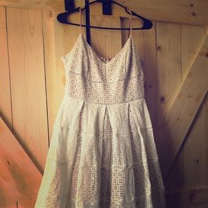 Lace tea length dress with blush underlay.